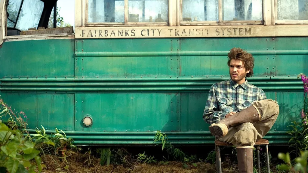 Chris McCandless sitting in front of the magic bus